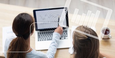 Two women looking on a laptop