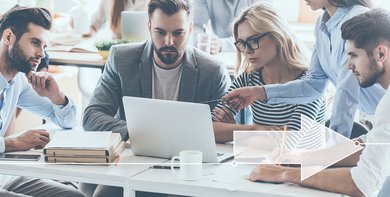 A group of people looking at a laptop together